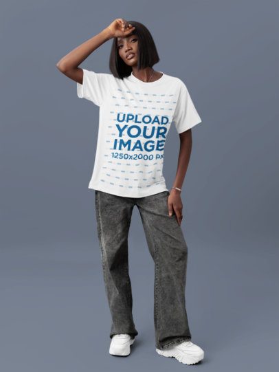 Round-Neck T-Shirt Mockup Featuring a Woman Posing With a Serious Look in a Studio