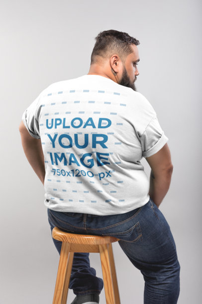 Back Shot of a Plus Size T-Shirt Mockup Featuring a Man Sitting on a Stool