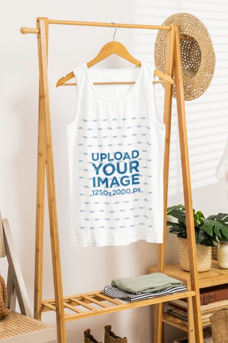 Mockup of a Comfort Colors Tank Top Placed on a Boho-Styled Wooden Rack