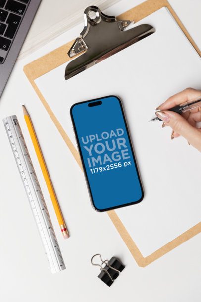 iPhone 16 Mockup Featuring a Woman's Hand Writing Something m55716