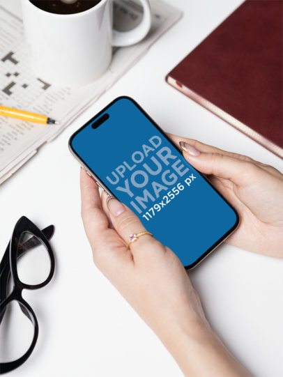 Mockup of a Woman Holding an iPhone 16 in a Corporate Setting m55717