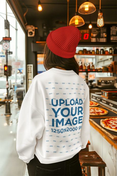 Back-View Sweatshirt Mockup Featuring an AI-Created Woman Walking in a Pizza Restaurant