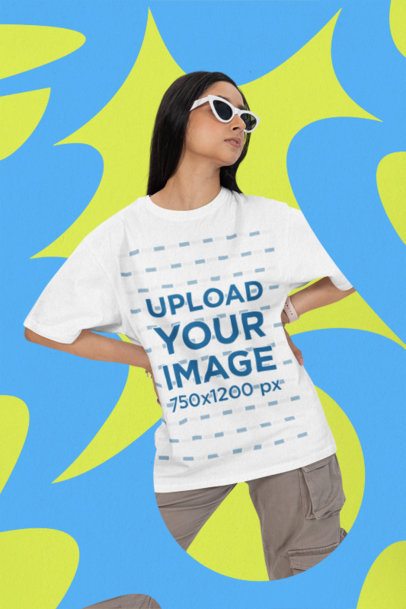Oversized T-Shirt Mockup Featuring a Woman With Sunglasses Posing Against a Textured Backdrop