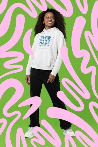 Pullover Hoodie Mockup of a Curly-Haired Woman Standing in an Abstract and Colorful Layout 7245-2
