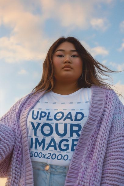 Round-Neck Tee Mockup of an AI-Generated Woman Posing With a Cardigan Against the Sky m52300