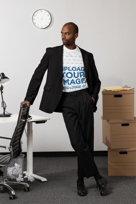 Comfort Colors Mockup Featuring a Man Wearing a T-Shirt and a Corporate Style Posing in an Office