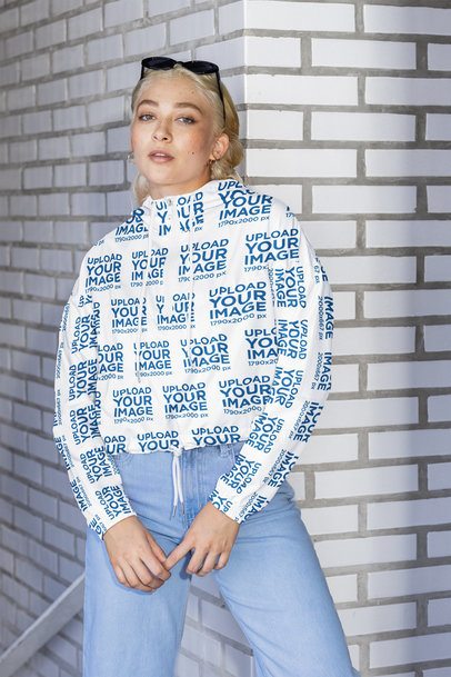 Windbreaker Jacket Mockup of a Woman Posing With a Serious Expression Against a Brick Wall