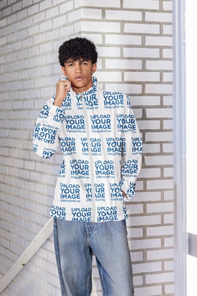 Windbreaker Jacket Mockup Featuring a Man Posing With a Serious Look Against a Brick Wall