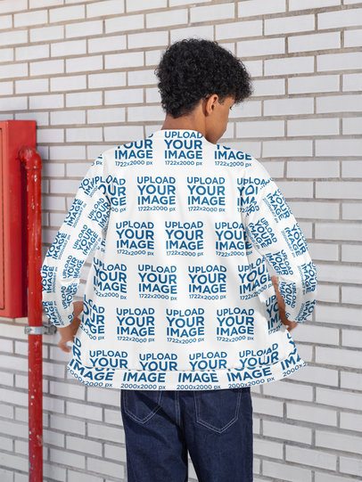 Back-View Mockup of a Man Wearing a Bomber Jacket in the Street