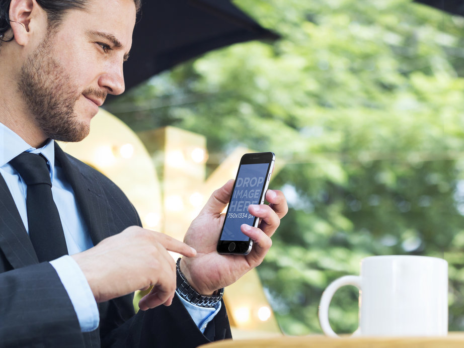 Mockup Featuring a Businessman Using an iPhone 6 at a Coffee Shop 