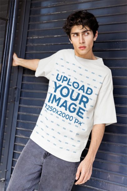 Oversized T-Shirt Mockup Featuring a Man Posing Against a Comercial Sheet Door m55819