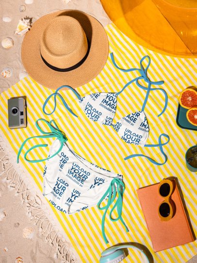 Summer-Themed Mockup of a Bikini Lying on the Beach in a Picnic Setting