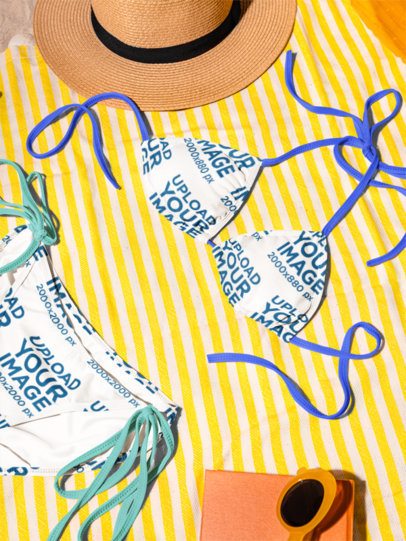 Mockup of a Sublimated Bikini Lying on a Towel in a Beach Setting m56220