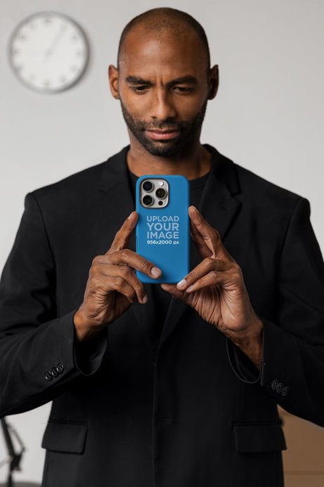 Mockup of a Man Holding a Phone Case While Taking a Picture