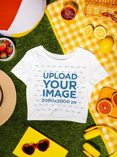 Mockup of a Bella Canvas Crop Top Lying on a Summer Picnic Setting m56204