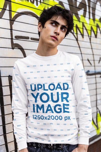 Comfort Colors Long-Sleeve Tee Mockup Featuring a Man Posing Against a Graffiti Wall m55823