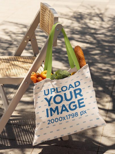 Mockup Featuring a Tote Bag Filled With Groceries Hanging on a Chair m56496