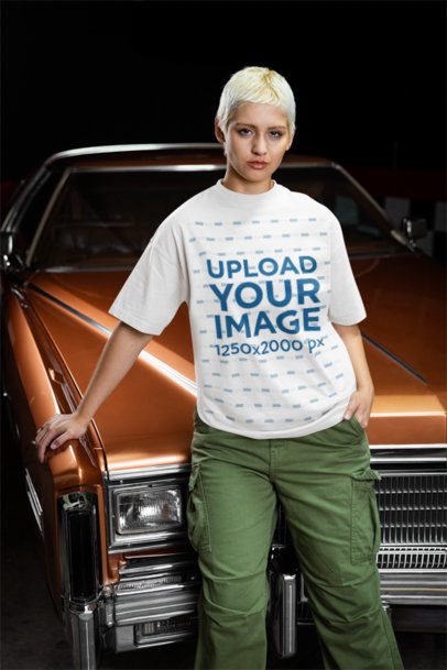 Oversized T-Shirt Mockup Featuring a Short-Haired Woman Posing Against a Vintage Car m56276