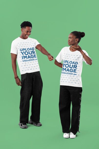 T-Shirt Mockup Featuring a Smiling Man Posing With a Confused Woman in a Studio