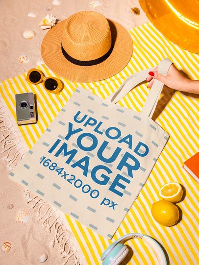 Mockup of a Woman's Hand Holding a Tote Bag in a Beach Picnic m56218