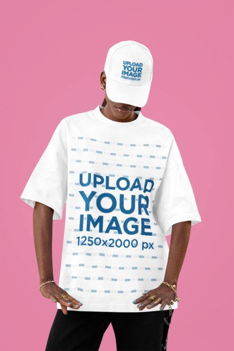 Oversized T-Shirt Mockup of a Woman With an Embroidered Dad Hat Posing in a Studio