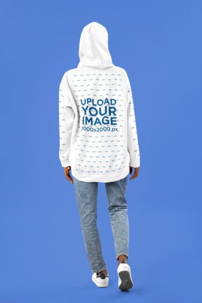 Back-View Hoodie Mockup Featuring a Woman Standing Straight in a Studio