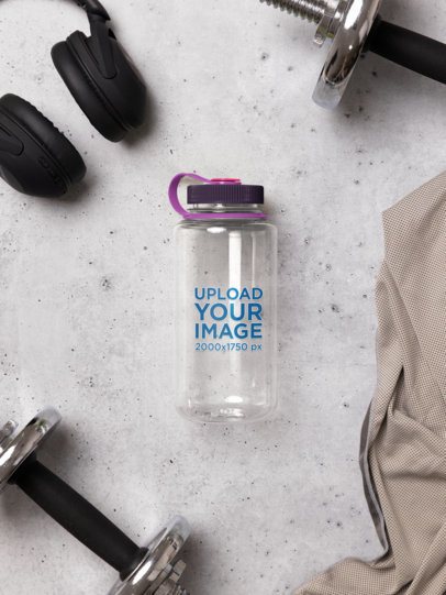 Nalgene Mockup Featuring a Water Bottle Lying on a Surface With Gym Stuff m55036