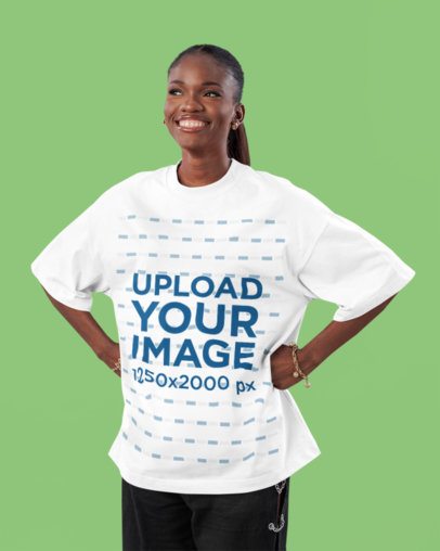 Oversized Tee Mockup Featuring a Woman Standing in a Studio With a Cheerful Expression