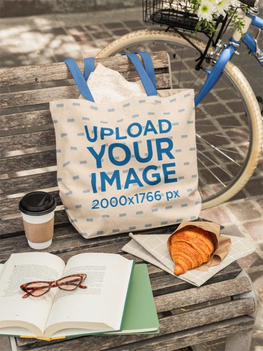 Bagmasters Mockup Featuring a Tote Bag Placed on a Bench With Coffee and Books