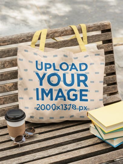 Mockup of an Econscious Tote Bag Placed on a Bench With a Pile of Books and a Coffee m56510
