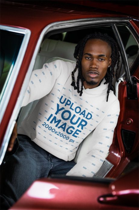 Comfort Colors Hoodie Mockup of a Man Posing Inside a Vintage Car