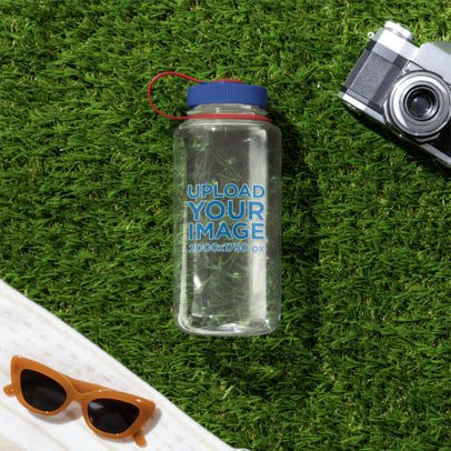 Mockup of a Nalgene Water Bottle Lying on the Grass With a Vintage Camera m55031