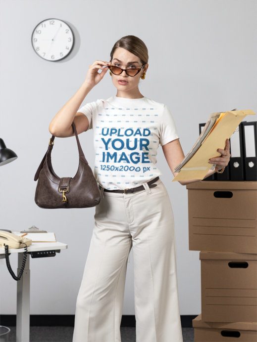 Bella Canvas T-Shirt Mockup of a Woman Holding Papers at an Office