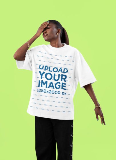 Oversized T-Shirt Mockup of a Woman Posing in a Studio While Making a Disappointed Look