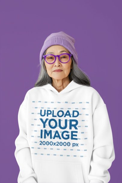 Hoodie Mockup Featuring an AI-Created Senior Woman Posing in a Studio With a Cool Style