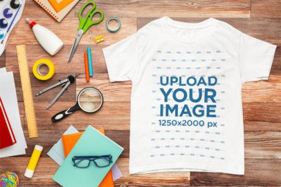 Back-To-School Mockup of a Gildan T-Shirt Lying on a Wooden Background m56722