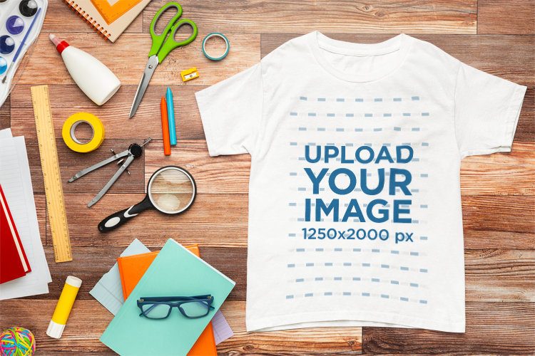 Back-To-School Mockup of a Gildan T-Shirt Lying on a Wooden Background
