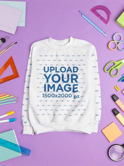 Mockup of a Gildan Sweatshirt Lying on a Surface Surrounded by School Supplies m56717