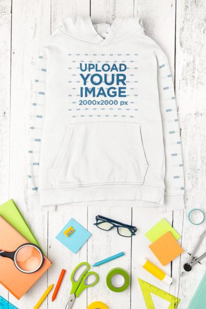 Hoodie Mockup Featuring a Wooden Surface With Back-To-School Supplies m56729