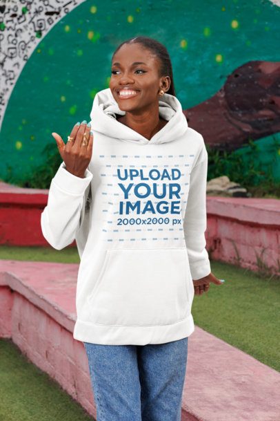 Pullover Hoodie Mockup of a Cheerful Woman Walking in a Park