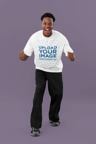 Oversized T-Shirt Mockup Featuring a Cheerful Man With a Winning Expression