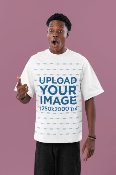 Oversized T-Shirt Mockup Featuring a Man With a Surprised Expression Posing in a Studio