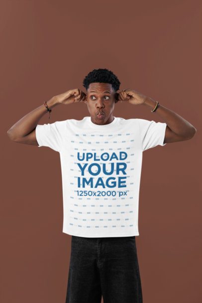 T-Shirt Mockup of a Man Making a Funny Expression While Standing Against a Colorful Background