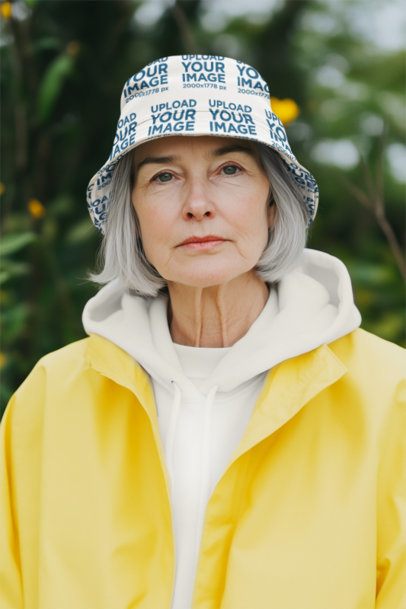 Sublimated Bucket Hat Mockup Featuring an AI-Created Senior Lady With a Rainy Coat m54862