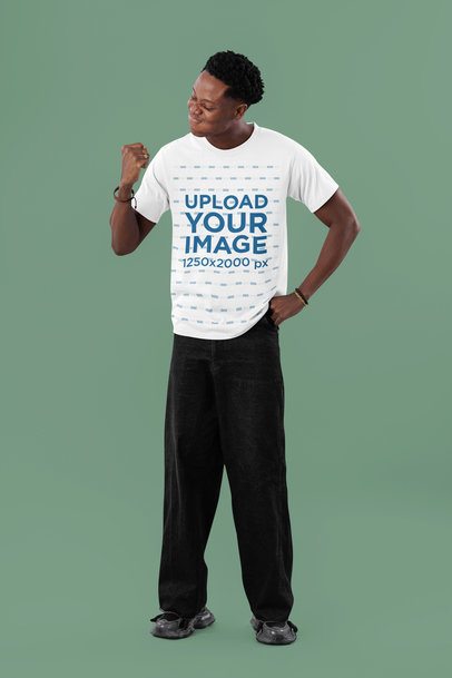 Round-Neck Tee Mockup of a Man Looking at His Fist in a Studio Setting