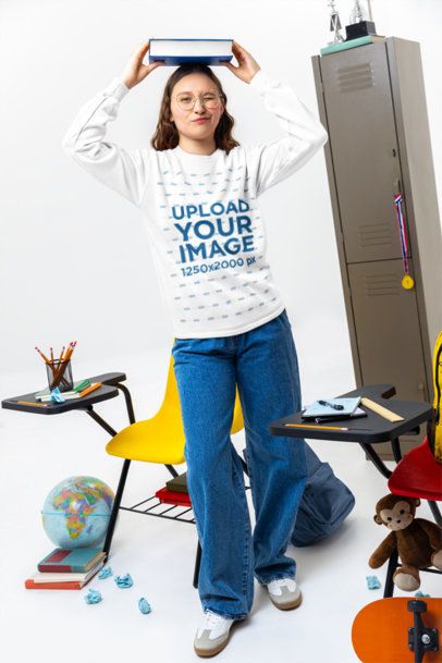 Comfort Colors Sweatshirt Mockup of a Young Woman Student Carrying a Textbook on Her Head m57183