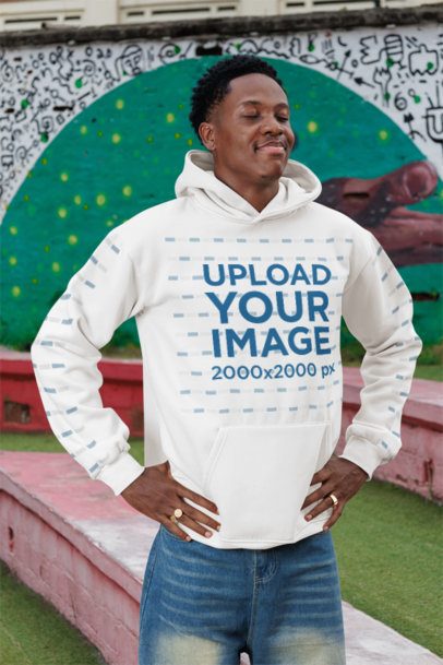Hoodie Mockup Featuring a Man With a Relaxing Expression Posing in an Urban Area