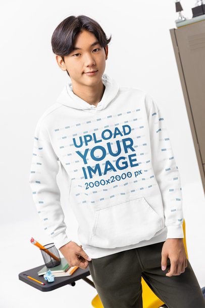 Comfort Colors Hoodie Mockup Featuring a Young Man Student Posing in a Classroom Setting m57181