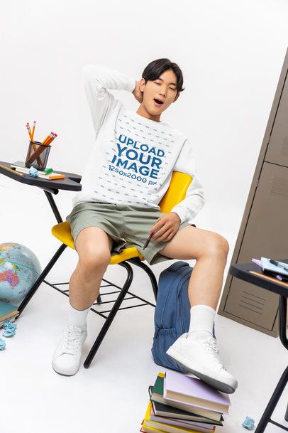 Comfort Colors Sweatshirt Mockup Featuring a Young Man Yawning in a Classroom Setting m57186