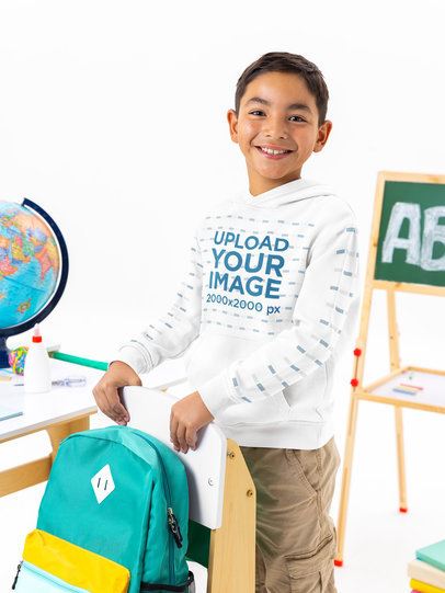Hoodie Mockup Featuring a Happy Boy Posing in a School Classroom-Themed Setting m56981